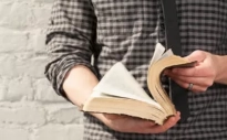 Person opening a Bible